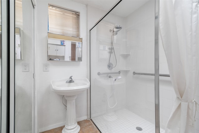 bathroom with a shower with shower curtain and tile patterned floors