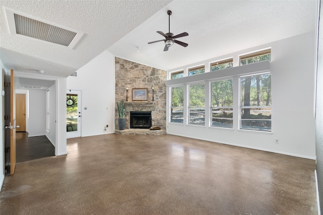 unfurnished living room featuring a textured ceiling, a stone fireplace, ceiling fan, and high vaulted ceiling