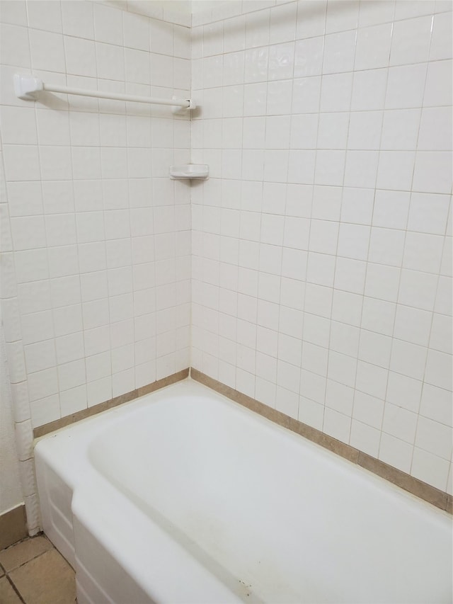 bathroom featuring a washtub and tile patterned floors