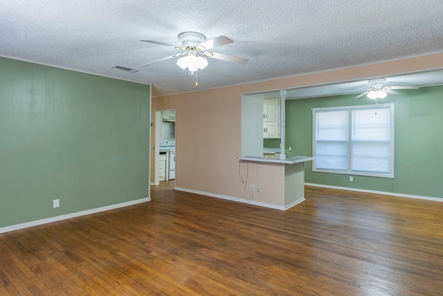 spare room featuring a textured ceiling, ceiling fan, and dark wood-type flooring