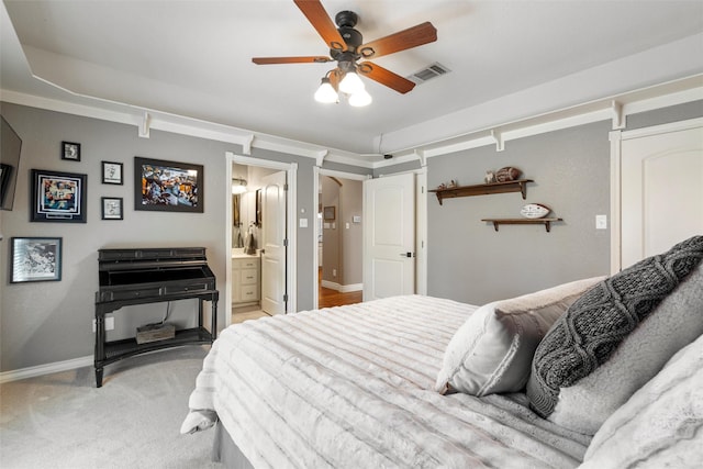 bedroom featuring ensuite bath, ceiling fan, and light colored carpet