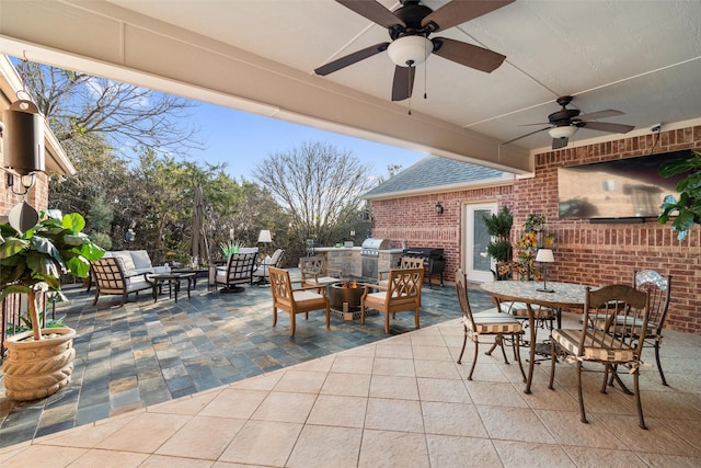 view of patio / terrace with an outdoor living space, an outdoor kitchen, and ceiling fan