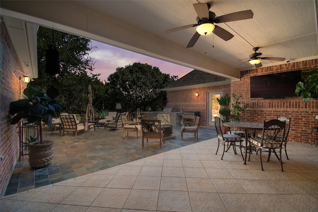 view of patio with area for grilling and ceiling fan