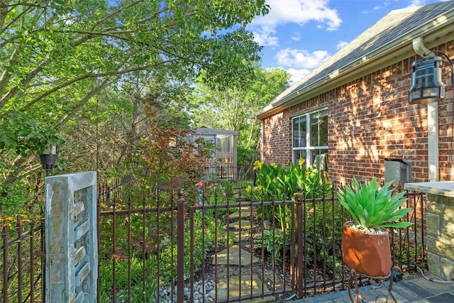 102 Ridge Ct, Glen Rose, TX 76043 - view of home's exterior with fence, brick siding, and a gate
