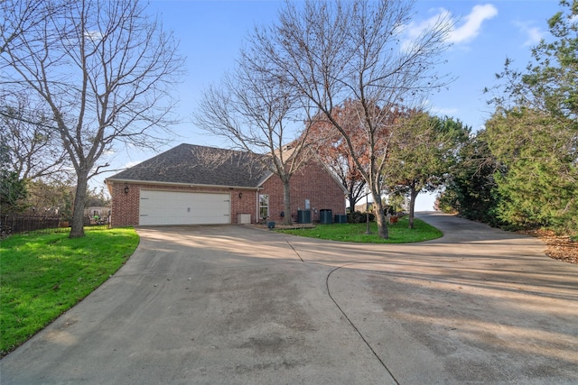 view of front of property featuring central AC unit, a garage, and a front yard