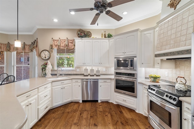 kitchen with dark wood-type flooring, white cabinetry, sink, and stainless steel appliances