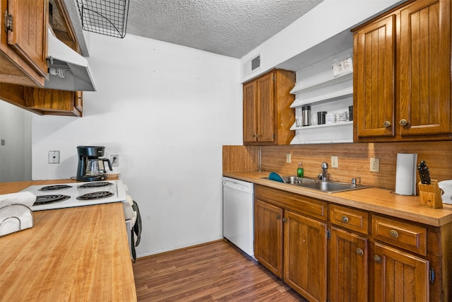 kitchen with a textured ceiling, sink, backsplash, white appliances, and dark hardwood / wood-style flooring