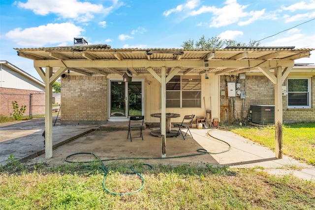 rear view of house featuring cooling unit and a patio