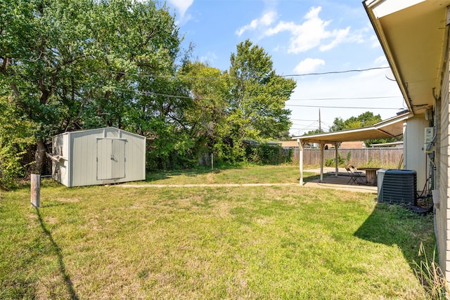 view of yard featuring a patio, a storage shed, and central AC unit