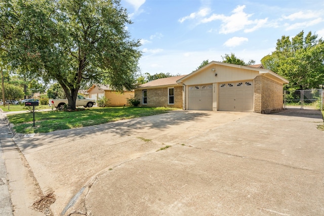 single story home with a garage and a front yard