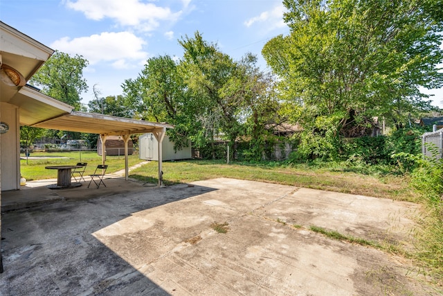 view of patio / terrace with a shed and a carport