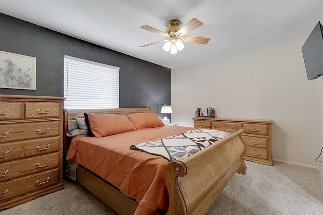 bedroom with ceiling fan and light carpet