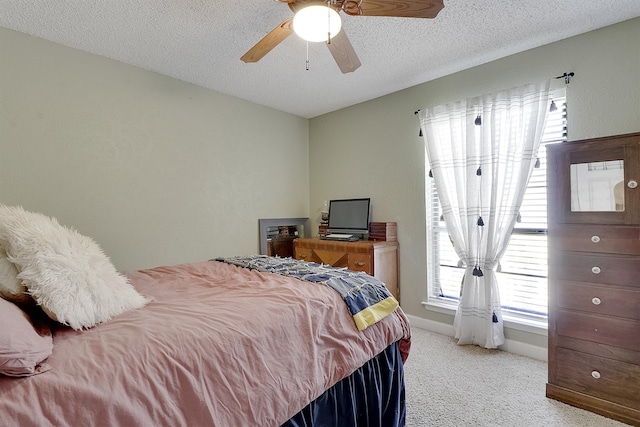 bedroom featuring light carpet, a textured ceiling, and ceiling fan