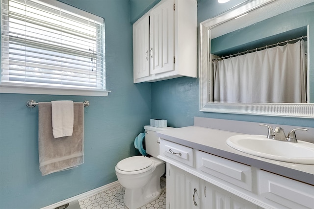 bathroom featuring tile patterned flooring, vanity, and toilet