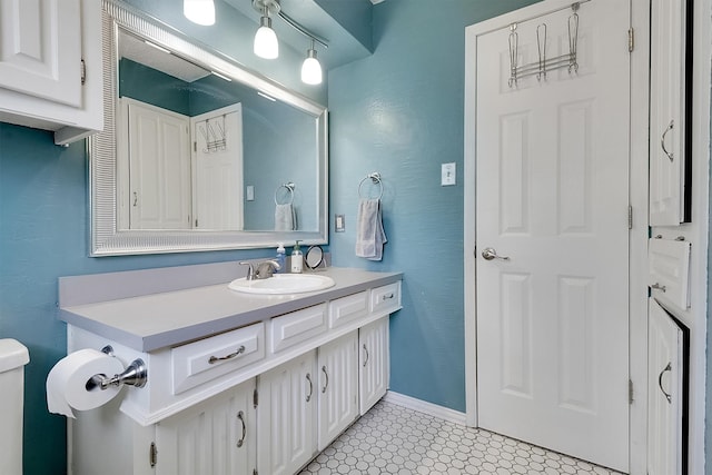 bathroom featuring vanity, toilet, and tile patterned floors