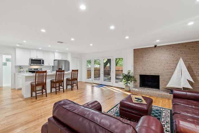 10606 Royalwood Dr, Dallas, TX 75238 - living area featuring a fireplace, recessed lighting, light wood-style flooring, and visible vents