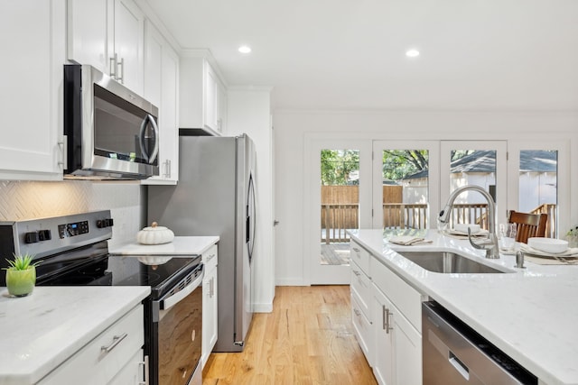 kitchen featuring white cabinets, appliances with stainless steel finishes, and sink