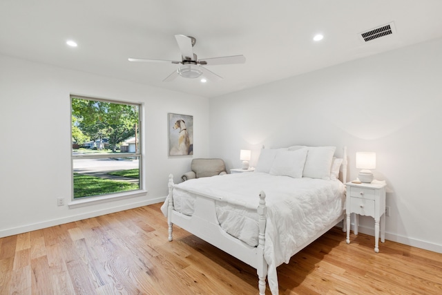 bedroom with light hardwood / wood-style floors and ceiling fan