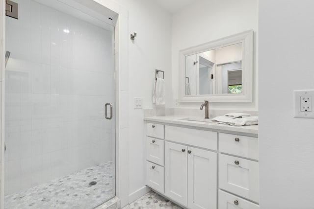 bathroom featuring an enclosed shower and vanity