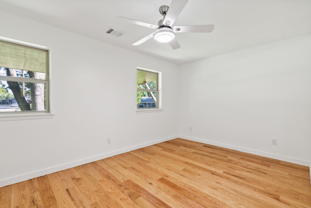 spare room with light hardwood / wood-style flooring and ceiling fan