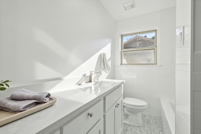 full bathroom with tile walls, vanity, tile patterned flooring, separate shower and tub, and toilet