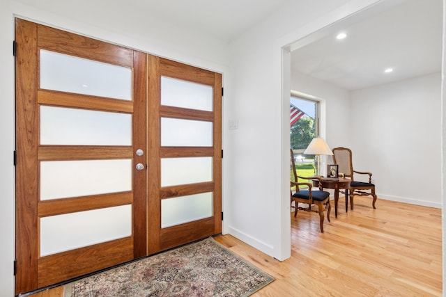 foyer entrance with light hardwood / wood-style floors