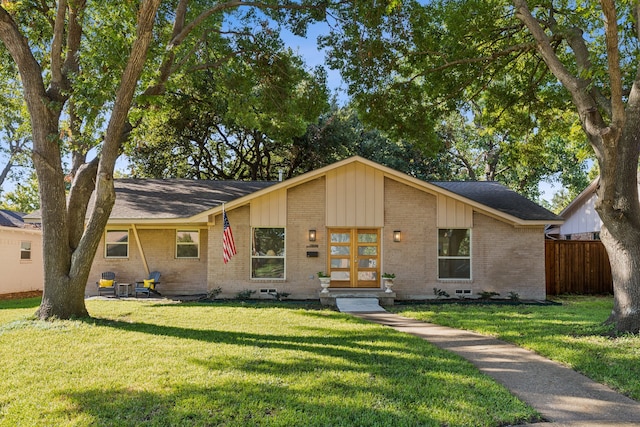 10606 Royalwood Dr, Dallas, TX 75238 - view of front of home featuring board and batten siding, brick siding, fence, and a front lawn
