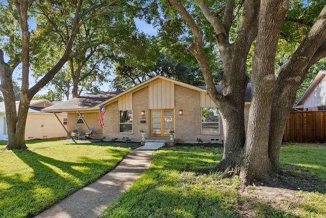 10606 Royalwood Dr, Dallas, TX 75238 - view of front of house with board and batten siding, brick siding, fence, and a front yard