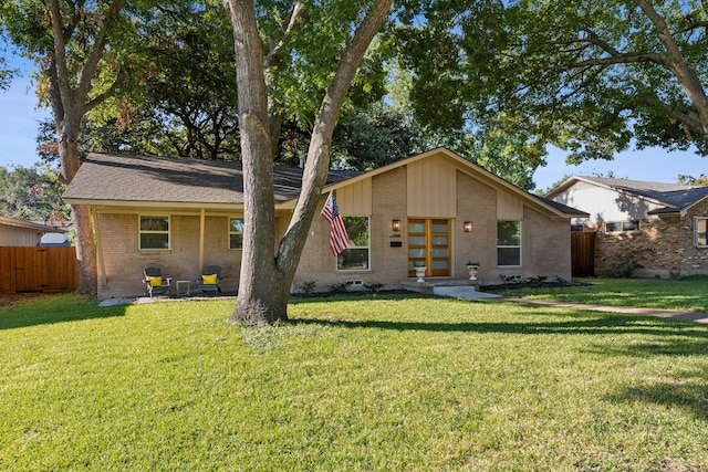 10606 Royalwood Dr, Dallas, TX 75238 - view of front of home featuring brick siding, fence, and a front yard