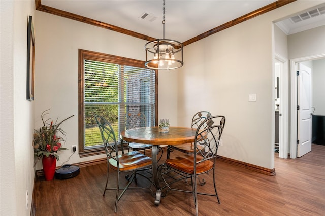 dining space with a chandelier, wood-type flooring, and ornamental molding