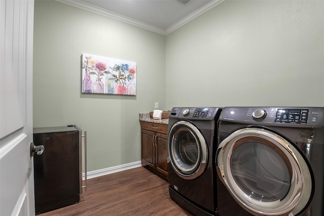 laundry room with separate washer and dryer, crown molding, cabinets, and dark hardwood / wood-style floors