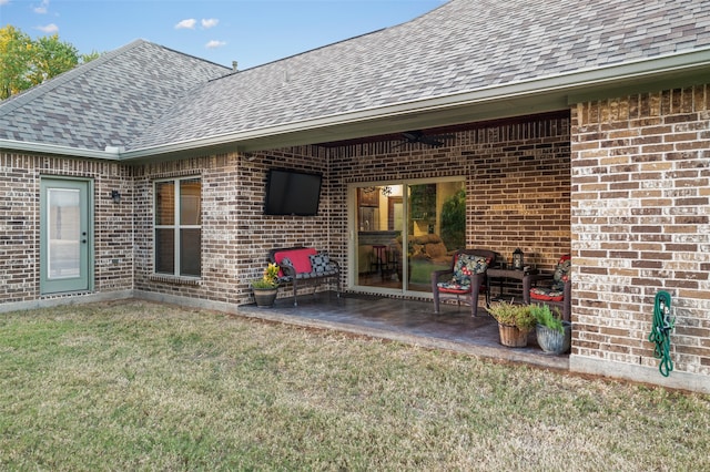 rear view of house featuring a patio area and a yard