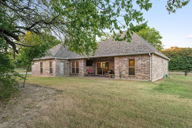 rear view of property featuring a yard