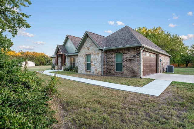 view of home's exterior with a lawn, cooling unit, and a garage