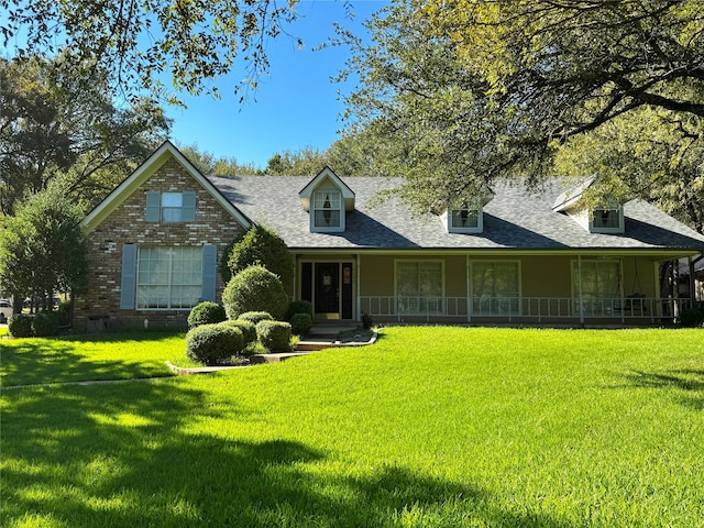 view of front of property with a front yard and covered porch