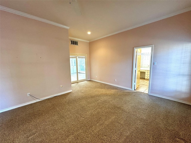 unfurnished room with carpet floors, baseboards, ornamental molding, and visible vents