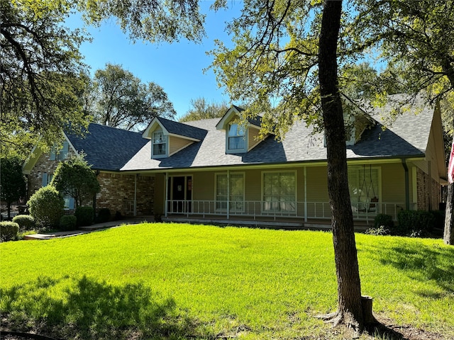 view of front of home with a front yard and covered porch