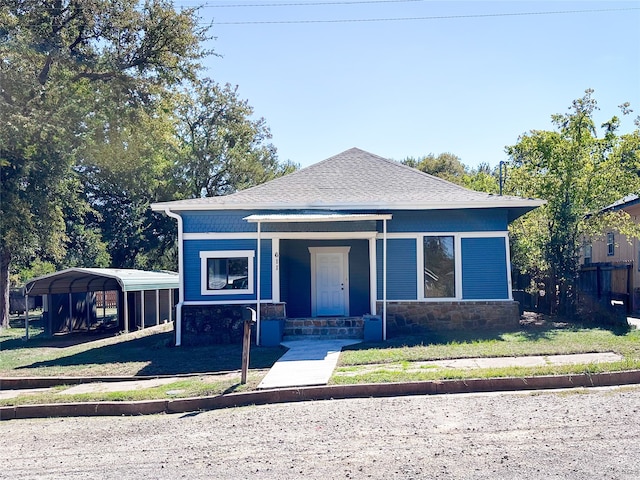 view of front of home featuring a front yard, a carport, and a porch