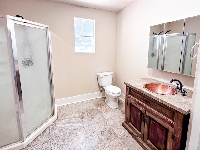 bathroom featuring a shower with door, toilet, and vanity