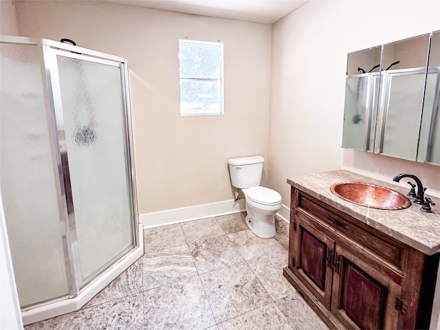 bathroom with vanity, toilet, and an enclosed shower