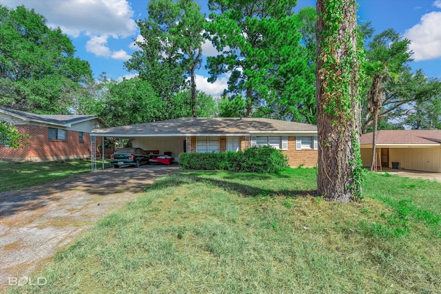 ranch-style home featuring a carport and a front yard