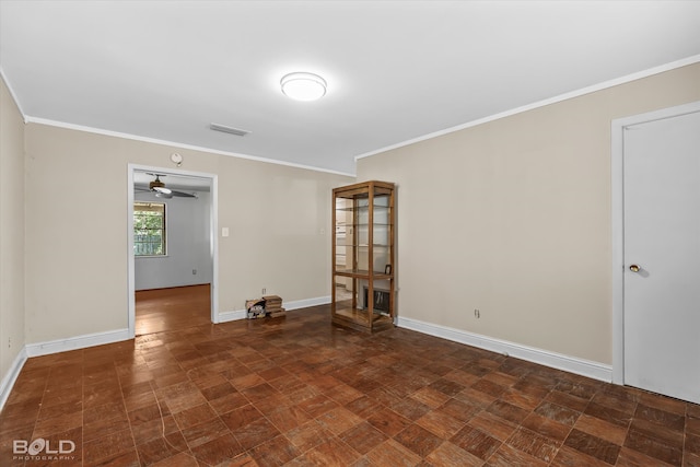 spare room featuring ornamental molding and ceiling fan