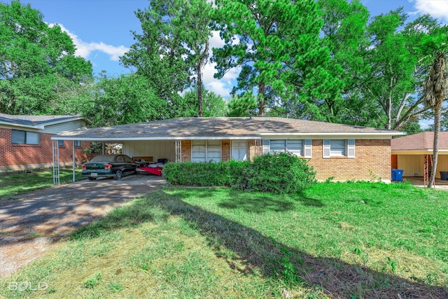 ranch-style home with a carport and a front yard