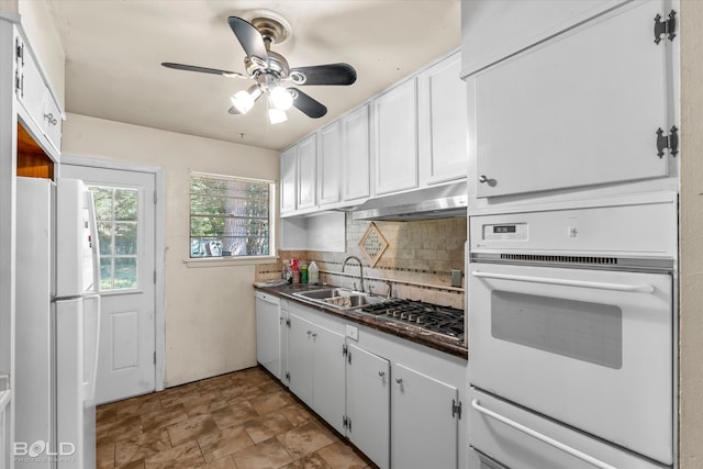 kitchen featuring sink, white cabinetry, decorative backsplash, white appliances, and ceiling fan