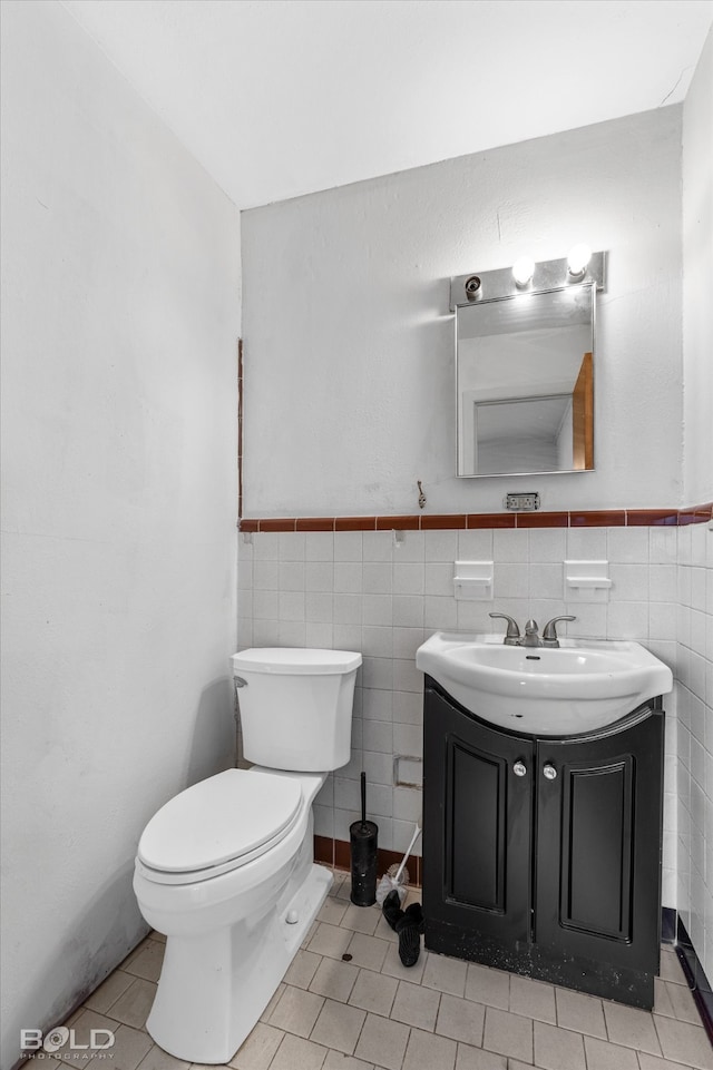 bathroom with vanity, tile walls, toilet, and tile patterned floors