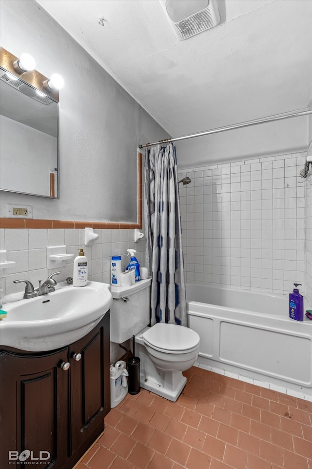 full bathroom featuring tile walls, tile patterned flooring, shower / bath combo, vanity, and toilet