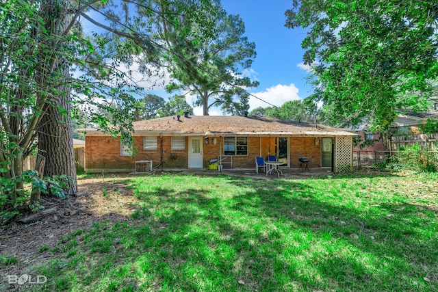 back of house with a patio, cooling unit, and a lawn