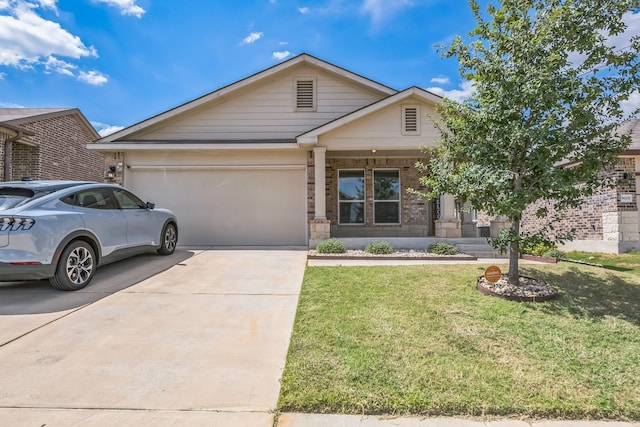 view of front of home featuring a front yard and a garage