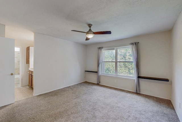 13818 Methuen Green Ln, Dallas, TX 75240 - unfurnished room featuring light carpet, baseboards, and ceiling fan