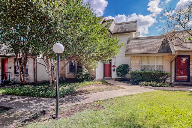 13818 Methuen Green Ln, Dallas, TX 75240 - townhome / multi-family property with brick siding, roof with shingles, and a front yard